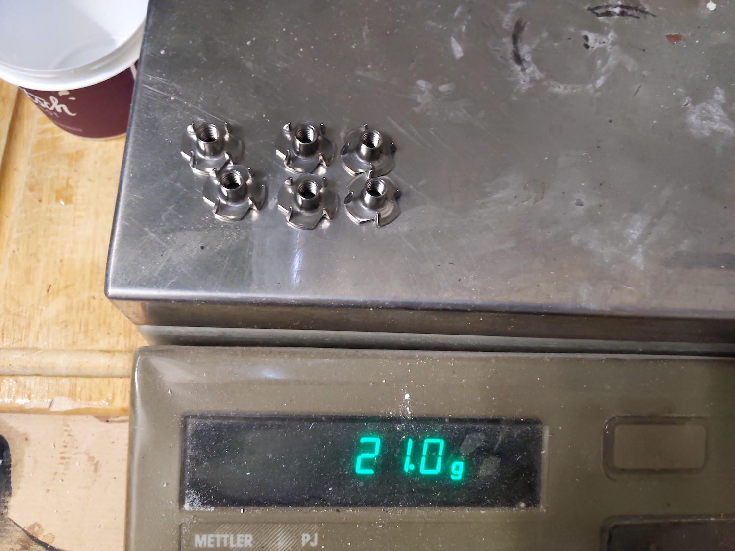 6 stainless seel drive-in nuts on scale - 21g