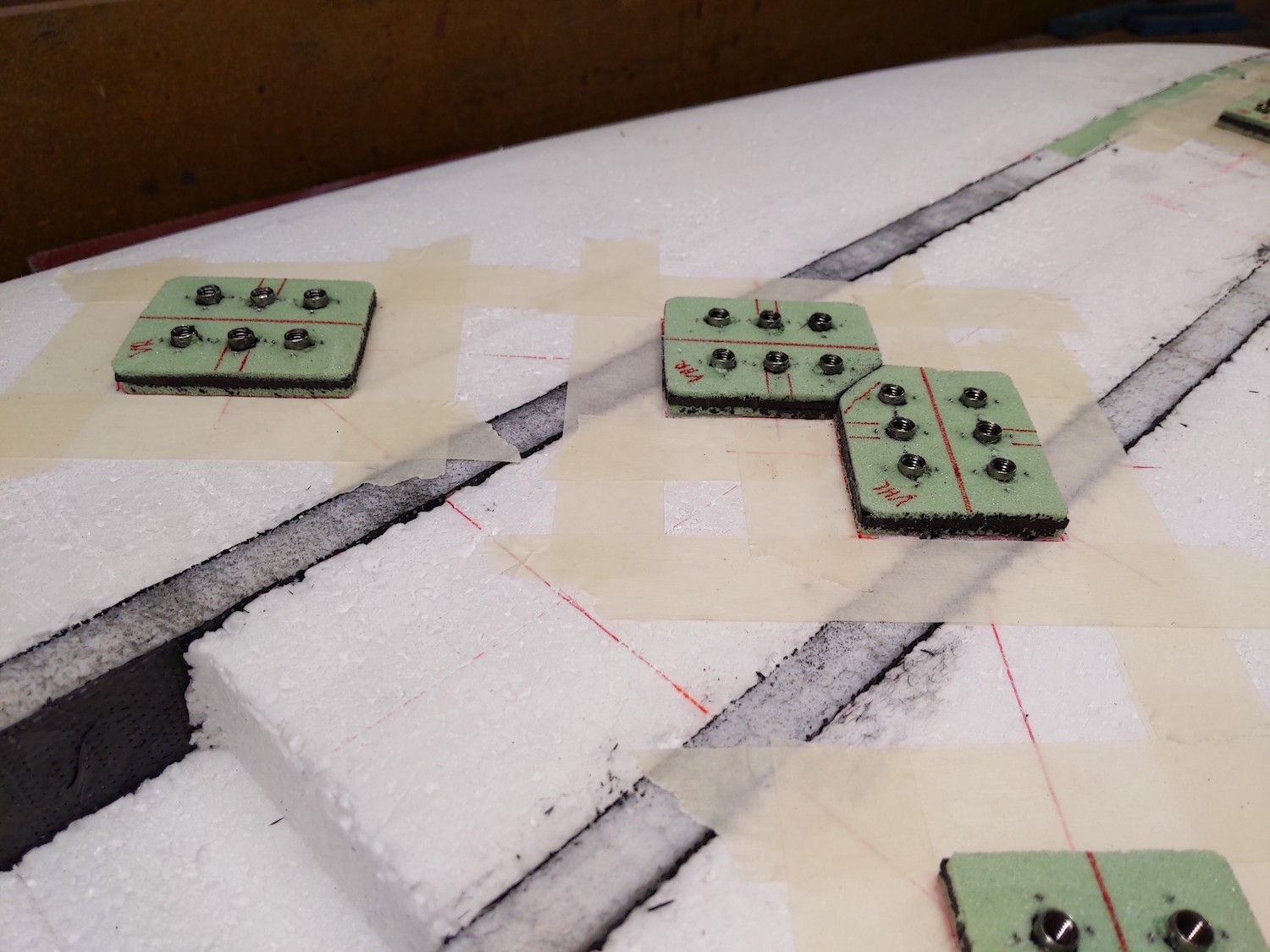 Custom carbon footstrap inserts with stainless steel M6 threads in windsurf board 1/2