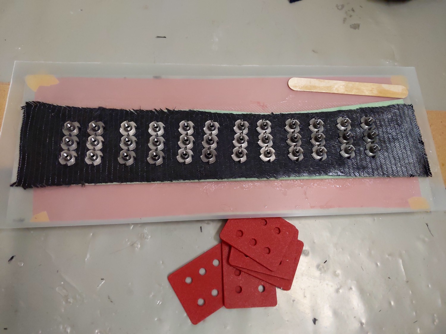 6 stainless seel drive-in nuts on epoxy soaked carbon cloth
